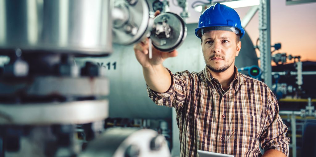 Man using tablet at Natural gas processing facility
