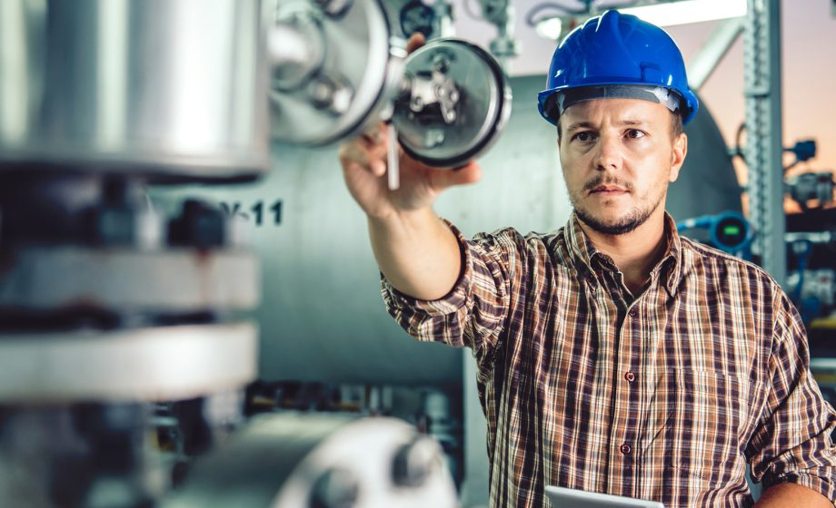 Man using tablet at Natural gas processing facility