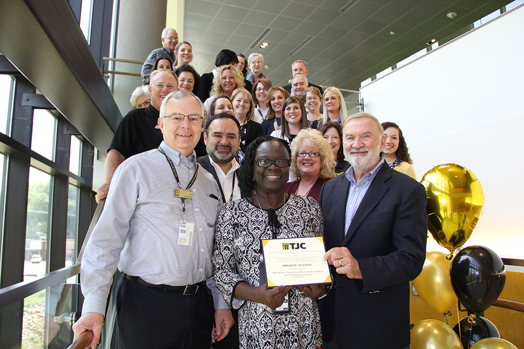 Seaton is surrounded by coworkers after being named the 2018 recipient of the Dorothy Fay and Jack White Endowed Chair for Teaching Excellence.