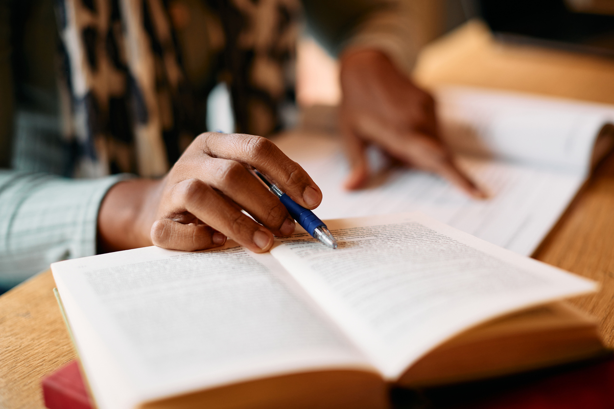 Close up of African American woman doing some research in a library.