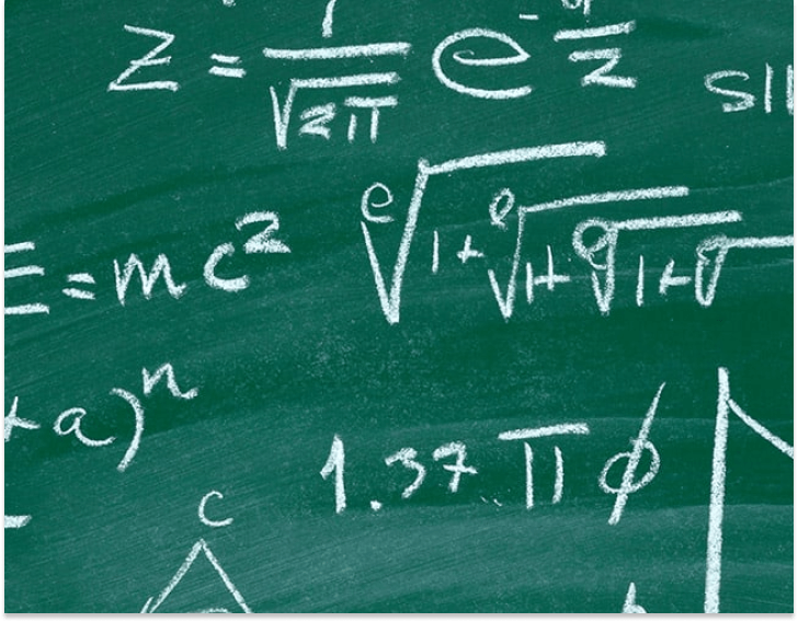 A chalkboard covered with white chalk mathematical equations and symbols, including 