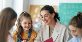 Happy kids and teacher at school