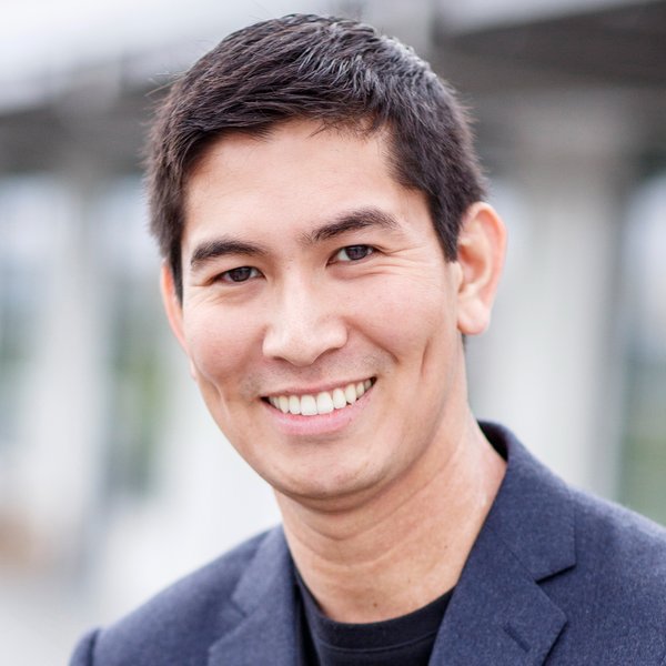 Hunter Torricke-Torres smiling outdoors in a dark blazer and black shirt.
