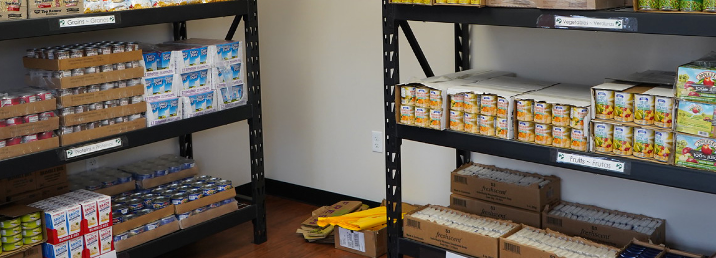 A shelf displaying a variety of food items, including canned goods, snacks, and packaged products.