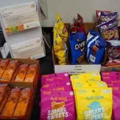 A table filled with various snacks and colorful candies arranged attractively for a gathering or celebration.