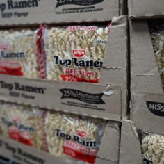 A box of ramen noodles displayed on a shelf, showcasing its colorful packaging and branding.